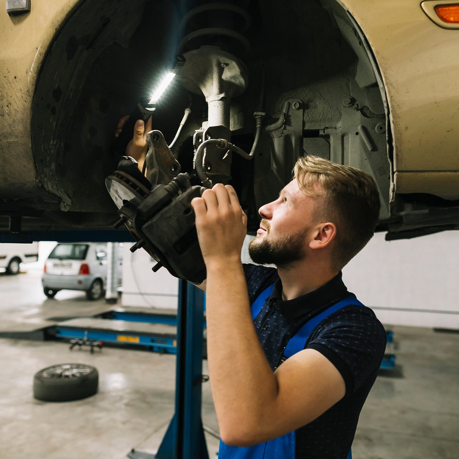 Mechanic examining Brakes